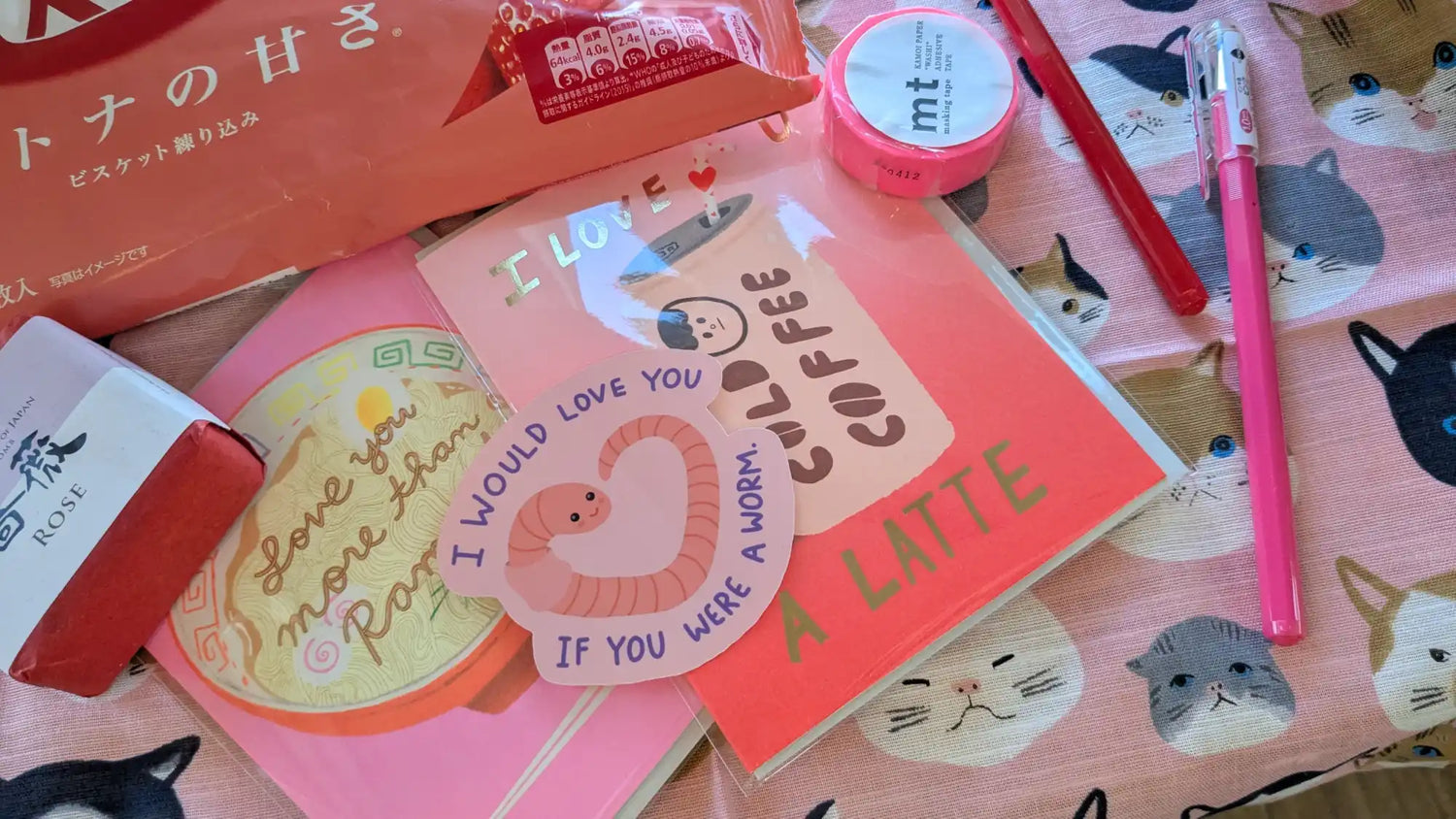 Collection of pink-themed stationery and treats.